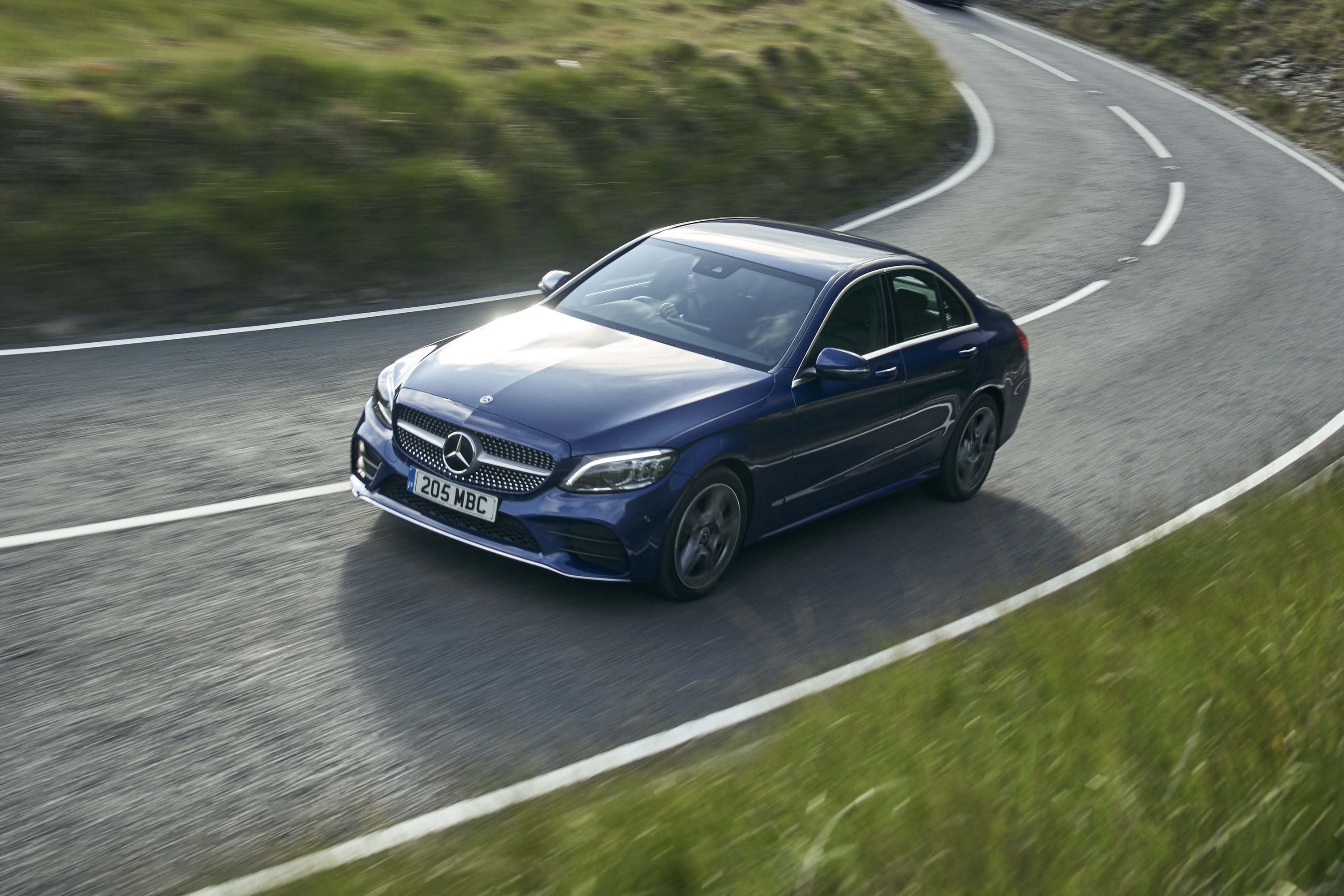 Mercedes c- class driving on a road